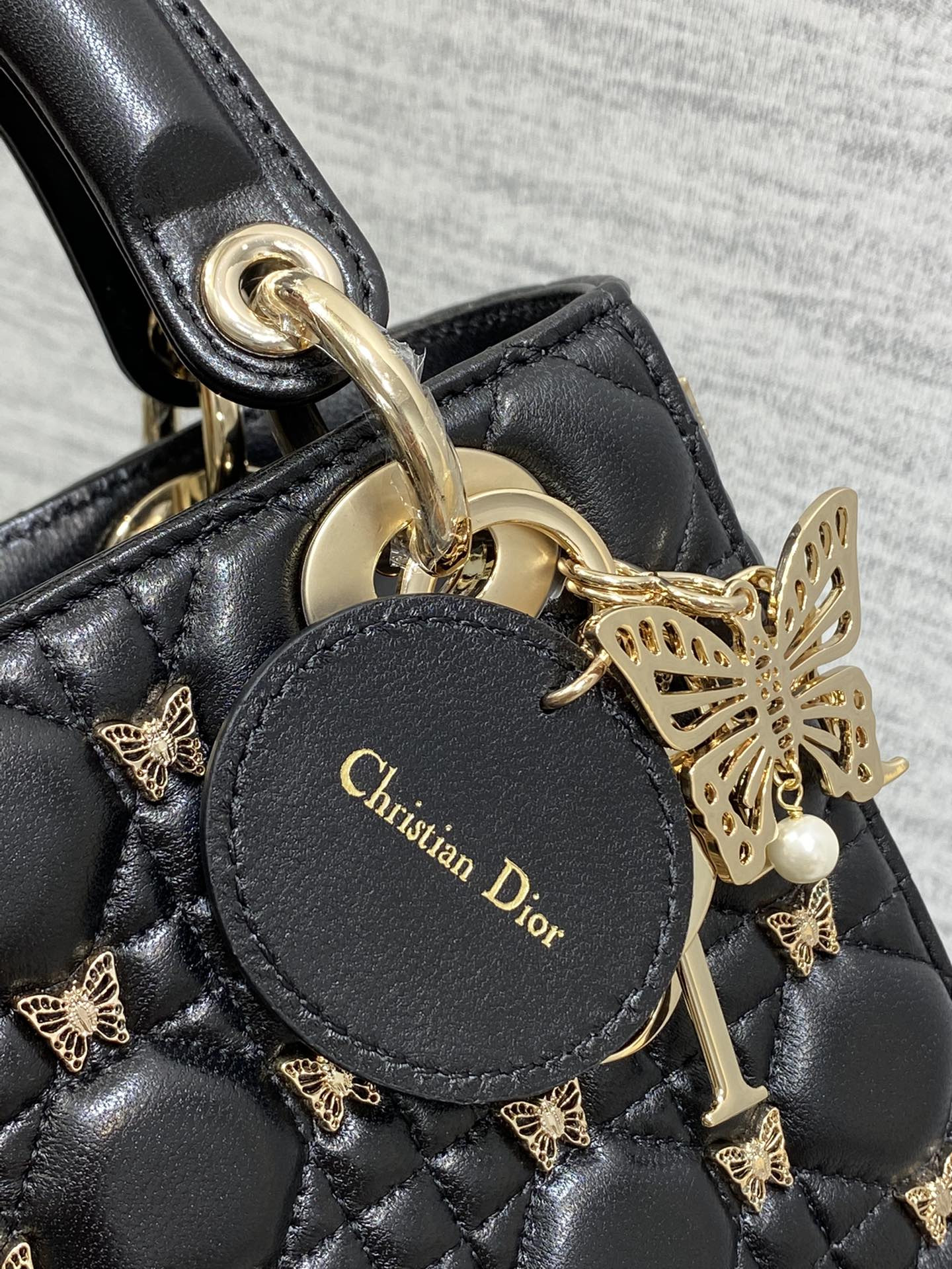 small lady D*or black with butterfly studs