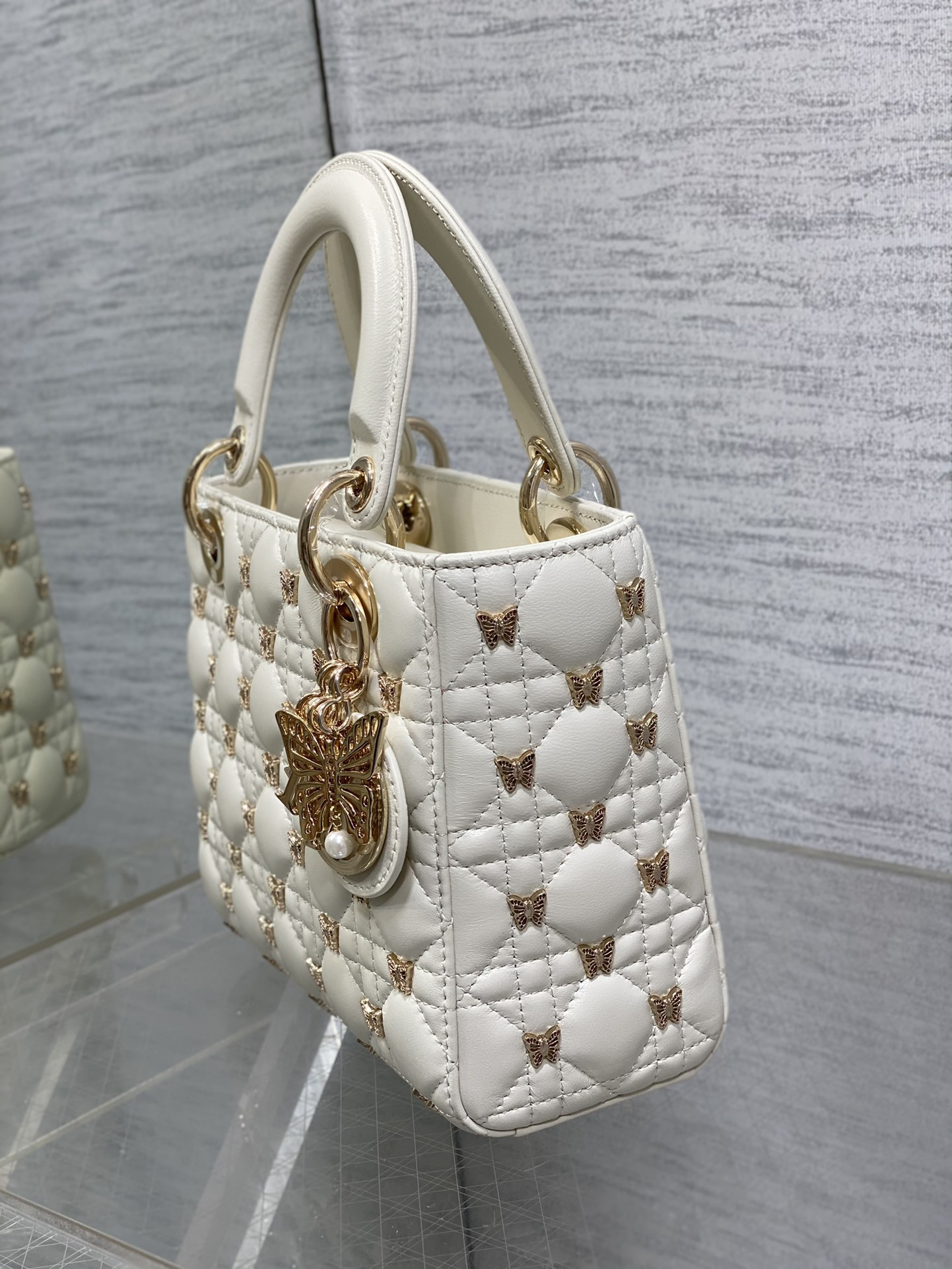 small lady D*or white with butterfly studs