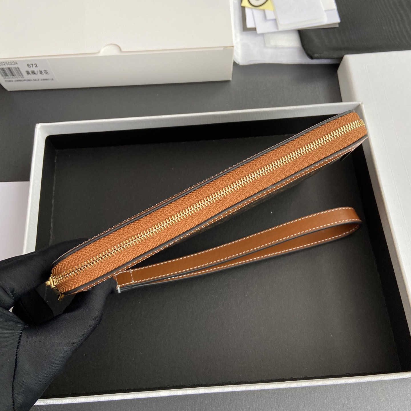 Ce**e long pouch with strap in triomphe canvas and calfskin 21.5x11.5x1cm